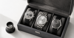 Mechanical watch, research notes, and marketplace listing tiles arranged on a collector’s desk