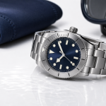 Dive Watches: Features That Matter and How to Compare Models A stainless-steel dive watch beside a map, diving mask, and folded fabric strap