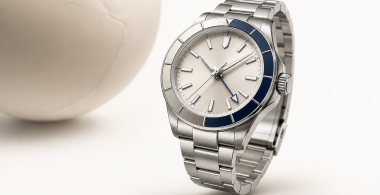 GMT watch with a 24-hour hand and rotating bezel beside a travel map