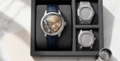 Collector examining several high-end mechanical watches beside reference notes
